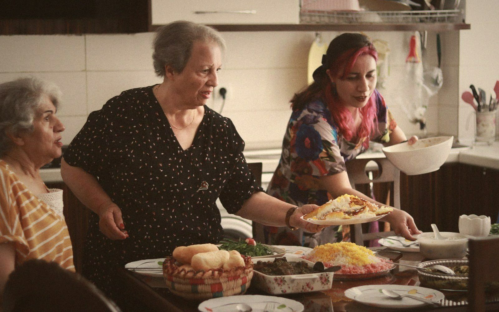 A family table mid-meal, dishes half served